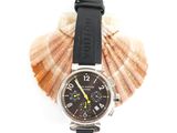 a watch that is sitting on top of a seashell