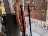 a mannequin of a woman standing in front of a store window