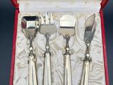 four silverware pieces in a red box on a table