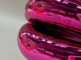 a close up of a shiny pink object on a table