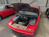 a red car with its hood open and a red car with its hood open