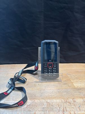 a cell phone sitting on a table next to a lanyard