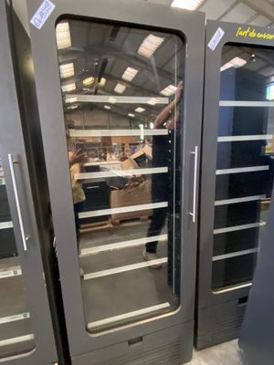 a man that is standing in front of a large oven