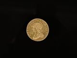 a gold coin on a black background