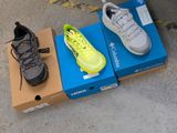 two pairs of shoes sitting on a box on the ground