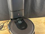 a robot vacuum cleaner sitting on top of a wooden table