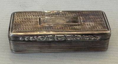 une vieille boîte en argent munie d'une poignée en métal, posée sur une table