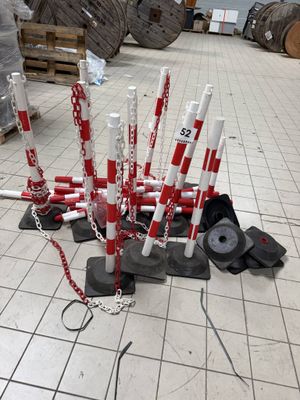 a bunch of red and white poles on the ground