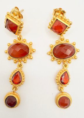 a pair of gold and garnet stone earrings