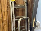 a ladder leaning against a wall next to a toilet