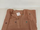 a brown shirt with polka dots on it sitting on a table