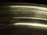 a close up of a silver plate with writing on it