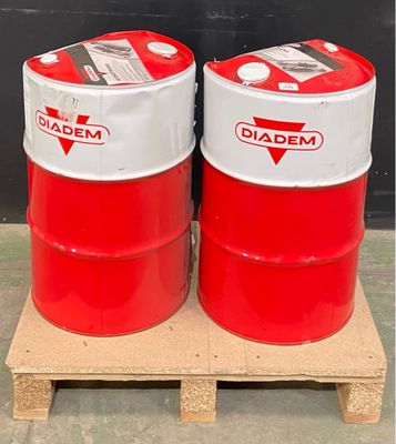 two red and white drums sitting on a pallet in front of a black wall