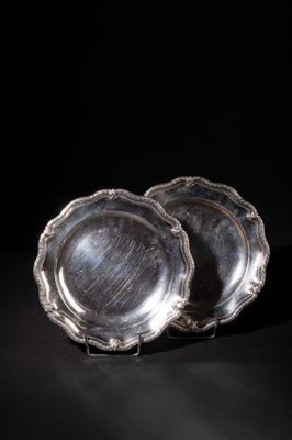 a pair of silver plates on a black background