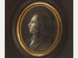 portrait d'un homme en costume-cravate dans un cadre noir et doré