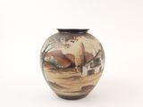 a vase with a painting on it sitting on a table