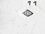 a silver plate with a clock and numbers on it