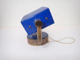 a small blue object on a stand with a cord