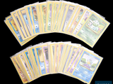 a lot of pokemon cards on a black background
