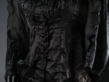 a woman wearing a black dress and a black hat