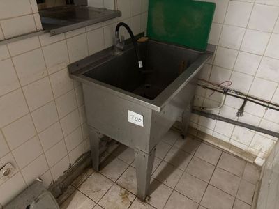 un lavabo dans un coin de la salle de bains, avec un couvercle vert