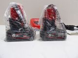 pair of red and black vacuum cleaners sitting on top of a table