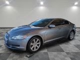 2011 jaguar xf in a clean garage with checkered flooring