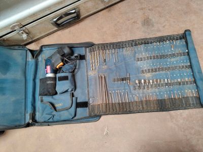 a suitcase with tools inside of it on the floor