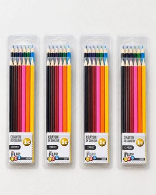 four different colored pencils in a package on a white surface