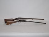 a pair of guns on a table with a white background