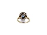 a close up of a ring with a blue stone in it