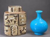 two vases sitting next to each other on a table
