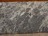 a marble slab on the floor in front of a cabinet