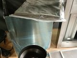 a trash can sitting on a table next to a window
