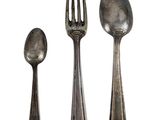three spoons and a fork sitting next to each other