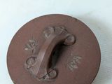 a brown button with a flower design on it