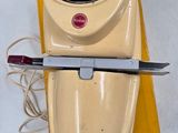 a yellow object with a knife on top of it