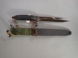 two knives that are laying next to each other on a table