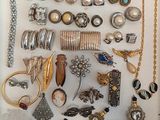 many different types of jewelry displayed in a display case
