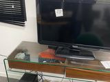 a glass desk with a computer and a monitor on it