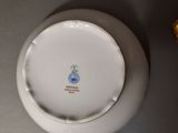 a white plate with a blue and green design on it