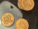 three gold coins sitting on top of a mouse pad