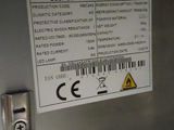 a close up of a sign on the door of a stainless steel refrigerator