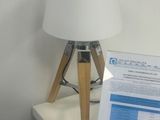 a table with a lamp and a sign on it