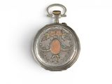a silver pocket watch with a floral design on it
