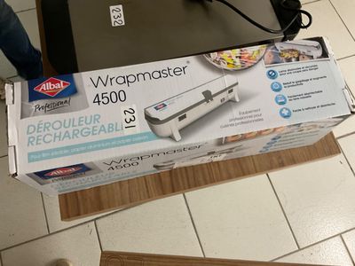 packaging of a wrapmaster machine sitting on top of a cardboard box