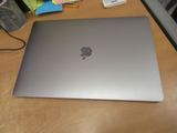 a silver apple laptop sitting on a wooden desk