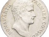 a close up of a coin with a man ' s face on it