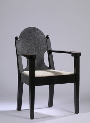 an image of a black chair with a beige seat on a white background
