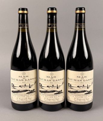 trois bouteilles de vin posées l'une à côté de l'autre sur une table